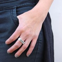 "Rectangle signet ring, suitable for both women and men, integrated with concrete, handmade of sterling silver. Super unique and modern piece of jewelry. This elegant ring is part of BAARA Jewelry's concrete jewelry collection. This collection is inspired by our love of the city landscape and architecture. We use concrete, a seemingly hard and industrial material to create small scale, modern works of art. This signet ring features a rectangle silver frame, filled with concrete, on a wide silver Modern Rectangular Signet Ring For Promise, Modern Silver Rings With Rectangular Stone, Modern Silver Ring With Rectangular Stone, Modern Rectangular Signet Promise Ring, Modern Sterling Silver Rings With Rectangular Stone, Minimalist Rectangular Engraved Ring For Everyday, Modern Everyday Rings With Rectangular Stone, Modern Everyday Ring With Rectangular Stone, Everyday Minimalist Engraved Rectangular Ring