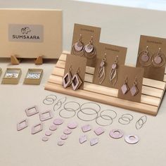 a display case with earrings and earring sets on it next to other jewelry items