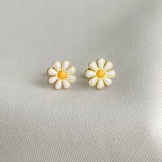 Daisy Earrings, a stunning accessory that effortlessly combines elegance and nature-inspired design. These unique earrings are a true testament to the beauty and vibrancy of daisies, making them a captivating addition to any jewelry collection.  The dainty flowers capture the essence of spring, radiating a sense of joy, freshness, and renewal. With their graceful charm, these earrings are perfect for adding a touch of femininity and sophistication to any outfit. ◆ Sold as a pair. ◆ Stainless Steel ◆Unique design ◆ Gold plated Packaging: All our jewellery comes in velvet bag or a jewelry box Thank you so much for visiting our store enjoy shopping with us ❤️ Stainless Steel Daisy Earrings, Daisy Flowers Earrings, Stud Daisy Earrings, Minimalist Women Earrings, Minimalist Stud Daisy Earrings Minimalist Birth Flower Earrings, White Flower Earrings As Gift For Her, Minimalist Hypoallergenic Flower Earrings, Minimalist White Flower-shaped Earrings, Nature-inspired White Drop Earrings, White Nature-inspired Drop Earrings, Minimalist Flower Earrings, Minimalist Flower Earrings For Pierced Ears As Gift, Minimalist Flower Drop Earrings For Gift