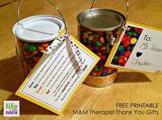 two tin cans filled with m & m candy and a free printable thank you gift card