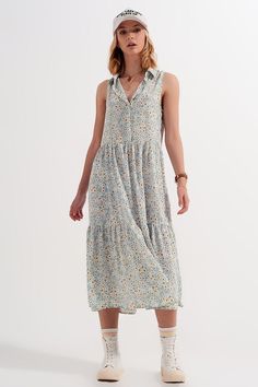 This super soft, breathable, and relaxed-fitting sleeveless shirt dress boasts of ruffled tiers and a blue floral pattern that is embellished with gold lurex threads throughout.  There are fabric-covered buttons that descend from the pointed collar neckline to the relaxed waistline.  The back has the same tiered, floral design.  The fabric is made from 100% soft Polyester.  Pair with sneakers for a casual-chic aesthetic, or add flats, sandals, or espadrilles. This dress is very versatile.  The m Sleeveless Shirt Dress, Fluffy Sweater, Blue Floral Pattern, Ribbed Midi Dress, Blue Floral Print, Satin Mini Dress, Flats Sandals, Midi Shirt Dress, Sleeveless Shirt