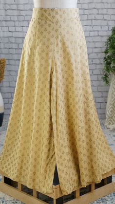 **Product color may have slight variations due to surrounding light** PRODUCT DETAILS A pair of Beige printed woven flared fit Palazzos, opaque, 1 pockets, and slip-on closure Size & Fit Small: 30 inches (expandable upto 36 inches) Medium: 32 inches (expands upto 38 inches) Large: 34 inches (expands upto 40 inches) X-Large: 36 inches (expands upto 42 inches) XX-Large: 38 inches (expands upto 44 inches) Length: 38 inches Material & Care Liva Hand-wash Specifications Occasion Ethnic Fit Fl Floor-length Bottoms For Spring Wedding, Fitted Ankle-length Bottoms, Fitted Cotton Set With Long Skirt, Fitted Cotton Sets With Long Skirt, Elegant Full Length Bottoms For Festive Occasions, Fitted Gold Pants For Festive Season, Festive Floor-length Party Bottoms, Traditional Fitted Full-length Pants, Cotton Floor-length Sharara