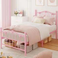 a pink bed with white sheets and pillows in a girls'bedroom, next to a window