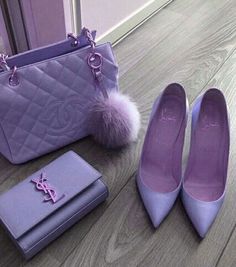 a pair of shoes, wallet and purse sitting on the floor