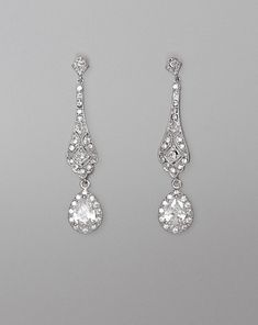 two pairs of diamond earrings on a gray background with clippings to the side