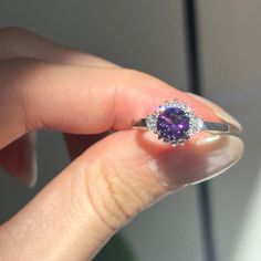 14KT white gold round, faceted amethyst and baguette and round diamond ballerina design ring. Size 6.5 (1) Genuine Round Faceted Amethyst Measures approx. 6.5mm Faceted Round and Tapered Baguette Ring Weighs 2.90 Grams 1/6 carat total weight SI2/3 clarity GHI color Prongs-set; One on each side Elegant Purple Cubic Zirconia Jewelry, Luxury Round Amethyst Ring With Center Stone, Elegant Diamond Amethyst Ring As Gift, Luxury Amethyst Ring With Center Stone, Elegant Purple Jewelry With Diamond Accents, Exquisite Amethyst Ring With Accent Stones, Elegant Round Purple Jewelry, Elegant Purple Round Jewelry, Elegant Amethyst Ring With Cubic Zirconia For Gift