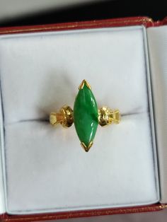 You are viewing a beautiful 24k solid gold jadeite marquise shape ring. The ring is size 4 1/4  suitable for small finger. The ring marked 24k in Chinese stamp inside  The ring itself measures approx. 17mm x 6mm wide. The band is 3mm thickness. The total weight of the  ring is 9.26 grams. The ring has a nice thickness to the name and heaviness to it...Its a pretty solid ring. The ring has a beautiful apple green jadeite jade marquise shape. Good condition . Classic Marquise Jewelry For May Birthstone, Classic Green Marquise Rings, Classic Marquise May Birthstone Jewelry, Marquise Emerald Ring For May Birthstone, Formal Green Marquise Emerald Ring, Classic Gold Marquise Emerald Ring, Classic Marquise Emerald Ring In Gold, Fine Jewelry Green Marquise Cut, Marquise Emerald Ring For Formal Occasions