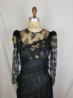 Good vintage condition Black lace Lace slip underneath 34 bust 32 waist 38 hip Has some stretch Sleeve 24 15 shoulders Black Lace Top With Lace Trim For Night Out, Fitted Dresses With Delicate Lace For Evening, Sheer Lace Top For Party, Sheer Lace Top For Parties, Fitted Lace Dress With Lace Patchwork For Evening, Black Lace Dress With Lace Trim For Night Out, Fitted Black Lace Dress For Wedding, Lace Dress For Evening, Sheer Fitted Lace Top For Party