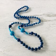 Vintage Lapis Lazuli Azurite Turquoise Long Beaded Necklace 28in Gorgeous Colors! It is composed of lapis lazuli, turquoise, and azurite round beads with small stations of turquoise pebbles for interest. This necklace is 28" long and has no clasp, and it slips over the head. The beads at the front center are 8 mm, followed by the small pebbles. The large turquoise rounds are 13.5 mm in diameter and flanked by 4mm round lapis beads. Above those, there is a 10mm round lapis bead on each side. The Adjustable Blue Turquoise Necklace With Gemstone Beads, Blue Single Strand Long Beaded Necklace, Blue Long Single Strand Beaded Necklace, Blue Turquoise Necklace With Round Beads, Bohemian Blue Round Beads, Blue Turquoise Gemstone Beads Necklace For Spiritual Style, Round Lapis Lazuli Beads With Natural Stones, Blue Lapis Lazuli Necklace With Large Beads, Lapis Lazuli Beads With Natural Stones