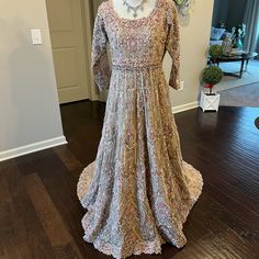 Hi, This Is A Beautiful Brand New Designer Piece, Perfect To Wear For An Engagement, Nikkah, Or Walima. I Will Consider All Offers! Thanks For Looking! Gold/ Beige Fabric With Gold/Silver/Pink Handwork Measurements For Dress: Shoulders: 15” Bust: 18” Waist: 17” Hips: 22” Dress Length: 65” From Front Side Pink Long Sleeve Anarkali Set For Reception, Anarkali Reception Dress With Dabka Detailing, Anarkali Dress With Dabka For Reception, Beige Floor-length Dress With Intricate Embroidery, Traditional Beige Floor-length Dress, Pink Naqshi Lehenga, Fitted Pink Gown With Intricate Embroidery, Pink Fitted Gown With Intricate Embroidery, Designer Pink Dresses With Intricate Embroidery