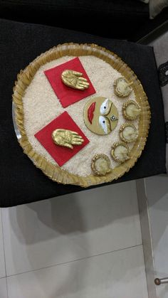 there is a plate that has some food on it with gold hands and feet in the middle