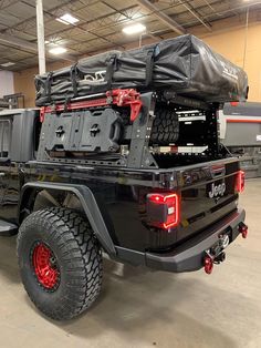 a large black truck parked in a garage