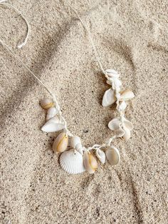 Embrace the essence of the ocean with our Boho Seashell Choker Necklace—an exquisite accessory for beach lovers and free spirits alike. Perfect for your next beach vacation, a seaside wedding, or simply adding a touch of coastal charm to your everyday look, this necklace captures the beauty of the sea in a minimalist, boho-inspired design. Handcrafted with natural seashells, each choker is a unique piece of ocean treasure that resonates with the tranquil vibes of the beach. Its simple yet elegan Cheap Beachy Shell Necklace As A Gift, Luxury Bohemian Shell Necklaces, Cheap Brown Shell Necklace For Gift, Cheap Shell Beaded Necklaces For Beach, Cheap Handmade Casual Shell Necklace, Affordable Beachy Shell Necklace, Cheap Bohemian Shell Necklace For Gifts, Small Seashell Necklace, Cheap Handmade Shell Necklace