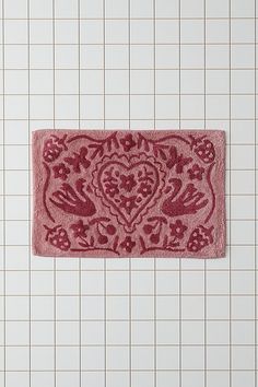 a bathroom rug with an ornate design on it