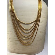 "A Vintage Trifari Signed Seven-Strand Necklace from the 1960s is a stunning piece of jewelry that exudes the charm and elegance of the era. This necklace is a true testament to Trifari's craftsmanship and design expertise, showcasing the brand's iconic style and attention to detail. Shortest strand clasp to clasp 21\" Condition: New Without Tags Excellent Condition. Never Worn." Gold-tone Multi-strand Necklaces For Formal Occasions, Gold-tone Multi-strand Necklace For Formal Occasions, Classic Gold Multi-strand Necklace, Vintage Gold Box Chain Necklace, Vintage Gold Necklace With Box Chain, Vintage Brass Box Chain Necklace, Antique Necklaces With Polished Finish For Anniversary, Antique Necklace With Polished Finish For Anniversary, Antique Polished Finish Necklace For Anniversary