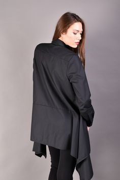 "Black Loose Shirt, Long Tunic, Asymmetric Top. Stylish and extravagant shirt in black. The model features loose fit cut and assymetric length. If you are looking for a comfortable but elegant long tunic this oversized top is a great match for your office or party look. Combine it with black bottom for all black look but add a colour popping accessory as an accent. ▲ Sizes: The item can be made in sizes from XXS to 7XL. Please, use the size chart below or if you are not sure about your size, jus Oversized Asymmetrical Cotton Shirt, Office Shirt With Shirttail Hem For Fall, Elegant Cotton Tops With Asymmetrical Hem, Asymmetrical Lagenlook Workwear Top, Asymmetrical Lagenlook Top For Workwear, Oversized Asymmetrical Shirt For Spring, Workwear Top With Relaxed Fit And Asymmetrical Hem, Black Asymmetrical Office Top, Black Asymmetrical Top For Office