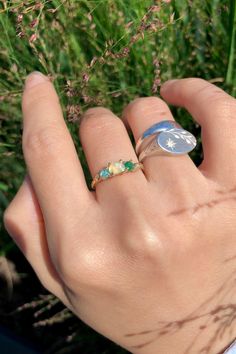 This Earthy Opal Engagement Ring is the perfect way to wrap your hands in love. These Rings are made with genuine Raw free-formed Opal, emerald and aquamarine in their natural state. It's crafted in a Solid Sterling silver/14k/18k Gold Specification: Gemstone: Raw Opal, emerald, aquamarine Center Opal Size: 4.5mm*5.5mm Materials: Solid Sterling Silver, Solid 14k/18k Gold Style: Engagement Ring *Gems: The raw gems natural hues vary, adding an organic touch to your ensemble. I'll try to select the Three Stone Aquamarine Jewelry As A Gift, Three Stone Aquamarine Jewelry For Gift, Three-stone Aquamarine Jewelry For Gift, Spiritual Round Emerald Ring For May Birthstone, Fine Jewelry Emerald Promise Ring With Birthstone, Green Three Stone Birthstone Ring In 14k Gold, Fine Jewelry Opal Promise Ring With Birthstone, Fine Jewelry Emerald Ring For Promise With Birthstone, Fine Jewelry Emerald Birthstone Ring For Promise