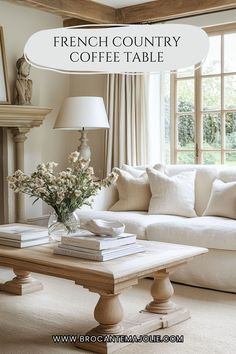 french country coffee table with flowers in vase and books stacked on the end, next to a white couch