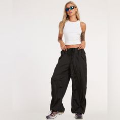 New Without Tags Color Black Size Medium In A Black Hue, These, Features A Low Rise Design With Fit And Tie Up Detailing. Edgy Black Parachute Pants, Urban High-waist Parachute Pants For Summer, Black 90s Style Summer Pants, Urban High Waist Parachute Pants For Summer, 90s Style Black Summer Pants, Trendy Black High Waist Parachute Pants, Black Parachute Pants For Night Out, Summer Stretch Parachute Pants For Streetwear, Summer Streetwear Stretch Parachute Pants