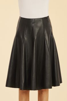 Our Faux Leather Paneled Skate Skirt, designed to blend sophistication and edge, is the perfect addition to your fall wardrobe. This knee-length, faux leather skirt features sleek panels and a flattering pleated silhouette that adds a playful yet structured look. The paneled design creates dynamic movement while offering a chic touch that pairs effortlessly with your favorite boots and sweaters. Faux leather Knee-length Paneled and pleated Available in Black and White Dry clean Style: 75484 Leather Flared Skirt For Night Out, Sleek Leather Skirt For Spring, Sleek Lined Skirt For Fall, Chic Accordion Pleats Mini Skirt For Fall, Leather Pleated Skirt For Work, Faux Leather Skirt For Formal Fall Events, Elegant Faux Leather Bottoms With Pleated Skirt, Leather Pleated Skirt For Party, Pleated Leather Mini Skirt For Fall