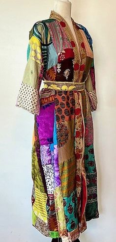 This stand-out kimono is full kaleidoscope of bright colors like a blooming spring garden. Constructed with high quality, ultra luxe sari silk, handmade. Designed as a traditional long kimono with an extra wide front band and self tie belt. Special detailing is noticable throughout the garment, double width hem panel, etc. Feels wonderful against your skin. Worn open, breezy flowing statement. The bright color pallet works well with most skin tones. True statement, one-of-a-kind designer piece. Multicolor Hippie Kimono With Kimono Sleeves, Hippie Multicolor Kimono With Kimono Sleeves, Bohemian Multicolor Patchwork Kimono, Multicolor Patchwork Kaftan With Kimono Sleeves, Multicolor Patchwork Kimono With Kimono Sleeves, Bohemian Multicolor Silk Kimono, Hippie Multicolor Kaftan With Kimono Sleeves, Long Multicolor Patchwork Kaftan, Multicolor Festival Kimono