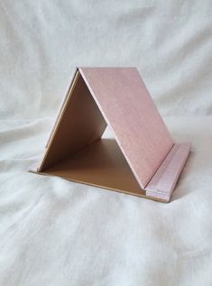 an open pink box sitting on top of a white sheet