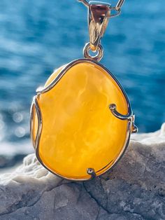 Pendant material and details : * White landscape Amber and Gold-plated Sterling Silver  * Stone : Natural Baltic Amber * Silver hallmark :Ag 925 * Pendant length : 5,5 cm * Pendant width: 3,5cm * Pendant weight: 13,0  g *Color :  White , Yellow Luxury Round Amber Jewelry, Luxury Amber Necklace With Polished Finish, Yellow Polished Pendant Jewelry, Luxury Amber Jewelry With Polished Finish, Yellow Pendant Jewelry With Polished Finish, Amber Citrine Cabochon Jewelry, Handmade Baltic Amber Gold Necklaces, Gold Baltic Amber Jewelry For Anniversary, Elegant Yellow Baltic Amber Necklaces