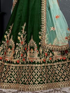 Look gorgeous in this stunning bottle green embroidered silk bridal lehenga choli from Ethnic Plus. This exquisite lehenga set is perfect for women who want to make a statement at their upcoming weddings and special occasions.
The lehenga is made of high-quality taffeta silk material in a beautiful bottle green color. It features intricate zari work, dori work, sequin work, diamond work, and embroidery work, adding a touch of elegance and sophistication. The attention to detail on this lehenga i Green Embroidered Sharara In Dola Silk, Green Anarkali Lehenga With Resham Embroidery, Embroidered Green Sharara In Dola Silk, Green Lehenga With Intricate Embroidery For Festive Occasions, Floor-length Green Lehenga With Resham Embroidery, Unstitched Green Embroidered Lehenga, Embroidered Green Lehenga For Reception, Bollywood Green Lehenga With Intricate Embroidery, Anarkali Style Green Lehenga With Resham Embroidery