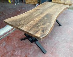 a wooden bench sitting on top of a cement floor