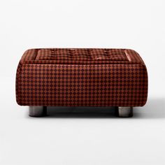 a brown and black checkered ottoman with metal legs on an isolated white background,