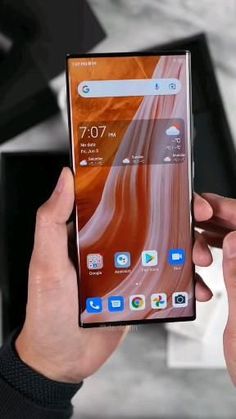 a person holding an lg phone in their hand and looking at the display screen