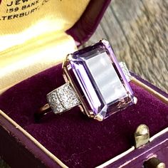 Details: Beautiful vintage mid-century amethyst ring set in 14K yellow gold filigree with diamond side details. The dramatic deep purple amethyst is large, measuring 15.9 x 11.8mm, and is surrounded by 24--1.6mm diamonds. This is a fabulous ring--you will not be disappointed! Please ask all necessary questions prior to placing an order. Measurements: The size is 6 US and can be sized for a fee. The amethyst measures 15.9 x 11.8mm. Ring weighs 6.7 grams. Condition: The overall all condition of th Elegant Lavender Amethyst Ring In 14k Gold, Elegant Purple Diamond Ring In 14k Gold, Elegant 14k Gold Purple Diamond Ring, Art Deco Purple Amethyst Ring For Formal Occasions, Purple Amethyst Art Deco Ring For Formal Occasions, Formal Art Deco Purple Amethyst Ring, Art Deco Amethyst Ring In Yellow Gold, Yellow Gold Amethyst Ring In Art Deco Style, Art Deco Yellow Gold Amethyst Ring