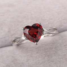 ◆ The ring is handcrafted from sterling silver and decorated with a dazzling 8*8 mm garnet and CZs. It is suitable for engagement/anniversary/daily occasion. ◆ Production Description: Main stone Type: Natural Garnet Main Stone Shape: Heart Cut Main Stone Size: 8*8 mm(2.44ct) Side stone: CZ Metal: 925 Sterling silver - Other options available in the drop down menu ◆ Customization: √Free for Add Engraving √Other Metal Type Available √Other Gemstones & Shapes Available √Personalization Requests Ava Garnet Heart Ring, Garnet Solitaire Ring As Gift, Silver Garnet Birthstone Ring For Promise, Garnet Birthstone Ring In White Gold For Promise, Garnet Diamond Ring With Accent Stones For Promise, Garnet Ring With Accent Stones For Promise, White Gold Garnet Birthstone Promise Ring, Garnet Rings With Accent Stones As Gift, White Gold Garnet Jewelry For Promise Ring