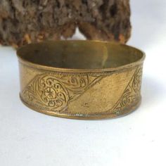 jewelry Bracelet Vintage African Bronze Berber Old Ethnic African Antique Engraved Moroccan Bracelet Hippy boho Womens Bangle Ethnic This breathtaking vintage bracelet is a perfect illustration of Traditional African craftsmanship. It has been made using bronze and brass, the large bangle is a showcase of rich cultural heritage and unique skill of the berber people. This vintage bracelet epitomizes excellent African and Moroccan jewelry development. It consists of bronze and brass with a massive Bohemian Brass Bracelet Jewelry, Bohemian Brass Bracelet, Bohemian Antique Gold Bracelets For Gift, Bohemian Festival Toe Ring Jewelry, Bohemian Style Toe Ring For Festivals, Bohemian Style Festival Toe Ring, Bohemian Toe Ring For Festivals, Bohemian Bronze Metal Bracelets, Round Brass Spiritual Bracelets