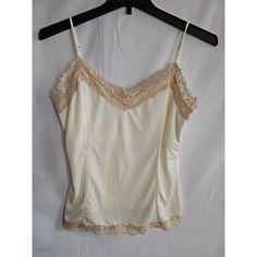 Add Some Color To Your Wardrobe With This Victoria's Secret Ivory Camisole. Perfect For Any Occasion, This Colorful Camisole Is Made Of High-Quality Polyester And Features Adjustable Straps For A Comfortable Fit. The Sleeveless Design Is Ideal For Hot Summer Days, And The Camisole Is Available In Size Large, Making It Perfect For Any Woman. Stay Stylish And Cool With This Victoria's Secret Camisole. The Camisole Is Also Equipped With Features Such As Straps And Accents, Making It An Excellent Ad Cream Camisole Top With Built-in Bra, Cream Camisole With Built-in Bra And Spaghetti Straps, Spring Cream Tank Top With Built-in Bra, Fitted Cream Camisole With Built-in Bra, Fitted Lace Tank Top For Daywear, Cream Camisole Sleepwear For Spring, Feminine Beige Lace Trim Tank Top, Beige Fitted Lace Tank Top, Feminine Cream Camisole Tank Top