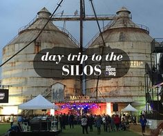 people are walking around in front of two silos with the words day trip to the silos on it