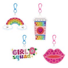 three different shaped magnets with the words girl squad on them and a rainbow in the background