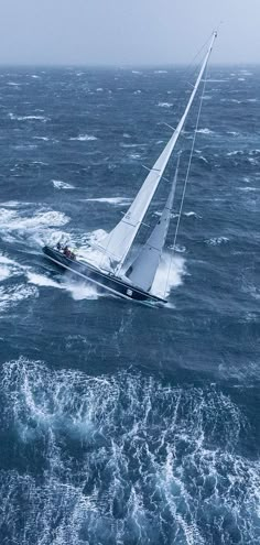 a sailboat in the middle of choppy water