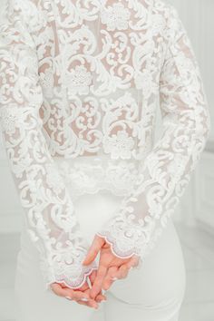 This is a beautiful bridal jacket made with high quality lace. This elegant lace wedding coat closures with a zip on the front. A wedding dress cover up ensures that no detail is forgotten. A bridal lace top can not only be the perfect thing to cover up and stay warm, it can also be a very luxurious compliment to your overall look. COLOR: - Cream White (Ivory) SIZE: Bust Waist Hips S 34.64 inch / 88 cm 25.19 inch/ 64 cm 36.22 inch/ 92cm M 36.22 inch/ 92 cm 26.77 inch/ 68 cm 37.79 inch/ 96cm L 37 Elegant Long Sleeve Gown With Scalloped Lace, Elegant Long Sleeve White Wedding Dress, Formal White Long Sleeve Wedding Dress, Elegant White Long Sleeve Wedding Dress, Elegant Embroidered Gown For Wedding, Elegant Gown With Intricate Embroidery For Wedding, Long Sleeve Wedding Gown With Pearl Embroidery, Fitted Long Sleeve Wedding Gown, Elegant Wedding Dress With Intricate Embroidery