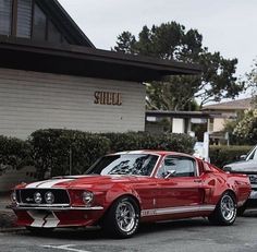 two cars parked next to each other in front of a building