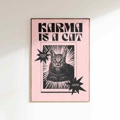 a black and white cat sitting on top of a pink poster hanging on the wall