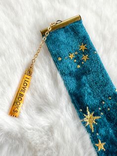 a keychain with a gold star on it sitting on top of a white blanket