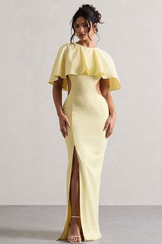 Embrace elegance in Isadora, our romantic maxi dress. Crafted in a pastel yellow shade, this figure-flattering piece skims over your curves with a contemporary cut-out for a cinched waist finish. Complete with a cape and open back, Isadora is the perfect pick for that upcoming summer wedding.  Features  - Premium woven - Crew neckline - Button-closed collar - Cape detail - Invisible zip closure  - Cut-out waist - High-leg split - Maxi length   Sizing & Fit  Model is 5'6" and wears UK size 8 / US size 4  Product Information  Designed exclusively by Club L London  Partially lined with no stretch  Premium woven in Pastel Yellow (95% Polyester, 5% Elastane)  157cm total length  SKU: CL132249166 Pastel Maxi Dresses, Wedding Features, Romantic Maxi Dress, Taylor Wedding, Midi Bridesmaid Dress, Dress With Cape, Club L London, Leg Split, Party Dress Long Sleeve