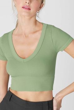 Seamless ribbed crop top teeV-necklineSoft hand feelMade in USAOne Size Fits Most    92% Nylon 8% Spandex    Hand wash cold separately, line dry recommended. Basic Green Seamless Tops, V-neck Seamless Summer Top, Everyday Green Seamless Crop Top, Green Ribbed V-neck Crop Top, Green Relaxed Fit V-neck Top, Denim T Shirt, Bohemian Bridal, Crop Top Tees, Ribbed Crop Top