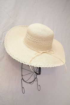 Vintage inspired wide brimmed straw hat. Hat features round crown, soft straw, and a matching ribbon trim along with lace trim. Inner crown features ties to adjust for head size. Product Details measurements: one size Brim- 4.72in Circumference- 23in material: straw imported Summer Hats With Crochet Trim, Summer Beach Sun Hat With Ribbon, Vacation Sun Hat With Ribbon And Short Brim, Summer Straw Hat With Ribbon For Vacation, Vacation Straw Hat With Ribbon And Short Brim, Summer Straw Hat With Ribbon For Beach, Spring Vacation Sun Hat With Ribbon, Spring Sun Hat With Crochet Trim And Curved Brim, Vacation Wide Brim Sun Hat With Ribbon