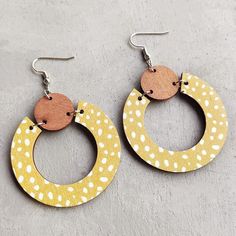 Add a touch of elegance to your outfit with our Beautiful Yellow Wood Circle Earrings. Crafted with care, these unique earrings are perfect for any occasion, featuring a soft and delicate yellow hue that adds a touch of femininity and sophistication to your look. 2 inches Trendy Yellow Earrings With Ear Wire, Trendy Yellow Hoop Earrings As Gift, Trendy Yellow Hoop Earrings For Gift, Handmade Yellow Drop Hoop Earrings, Handmade Yellow Circle Earrings, Yellow Single Dangle Earring, Single Yellow Dangle Earring, Trendy Yellow Drop Earrings, Yellow Drop Hoop Earrings As Gift