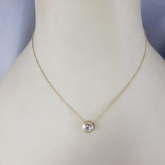 14 Karat Yellow Gold Diamond Solitaire Necklace-  This sparkling solitaire necklace features one round brilliant cut diamond set in classic 14K yellow gold.  Approximate total diamond weight:  .42 ct. - .50 ct.  Diamond clarity:  VS  Diamond color: G  Stamped: 14K  Size:  16 inches (necklace)            8 mm (pendant)  Weight:  1.7 dwt. / 8.2 gr.  *Stone weights are approximated and calculated by formula.  Very good condition, professionally polished.  Will come packaged in a gift box or pouch (when possible) and will be shipped U.S. Priority Mail Insured. Gold 14k Diamond Necklace With Single Diamond, Anniversary Solitaire Necklace With Diamond Accents, Timeless Gold Solitaire Necklace With Round Stone, Timeless Yellow Gold Solitaire Necklace With Round Stone, 14k White Gold Solitaire Necklace With Round Stone, Yellow Gold Diamond Necklace With Bezel Setting, Solitaire Necklace With Round Pendant For Formal Occasions, Gold Solitaire Necklace For Formal Events, Gold Solitaire Necklace With Round Stone For Formal Occasions