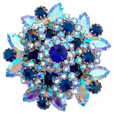 - Vintage item - 2" diameter - 1" depth - Rhodium plated (silver tone) - Prong set blue Aurora Borealis (AB) iridescent navette crystal rhinestones - Prong set navy blue round crystal rhinestone accents - Manufactured by DeLizza & Elster for Vendome (signed on verso) - Circa 1960s - Estate acquired - This item has been cleaned & polished and is ready to wear - Excellent vintage condition Layered Cocktails, 1940s Jewelry, Vintage Badges, 1970s Jewelry, Hand Jewellery, Blue Aurora Borealis, Costume Jewelery, Blue Aurora, Beaded Charms