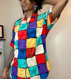 Fabulous multi colored button down top! Beautiful & bright colors! Shoulder pads.  Tag has been removed, but fits like an XL Measurements (measured flat): Shirt length 30 inches long Sleeve length 9.8 inches Bust 21 inches  In Excellent vintage condition!  No rips or tears.  Model is 5'9 in height and wears a size medium top Multicolor Collared Shirt With Vibrant Print, Trendy Multicolor Shirt With Vibrant Print, Multicolor Vibrant Print Button-up Shirt, Summer Multicolor Blouse With Buttons, Casual Multicolor Shirt With Vibrant Print, Multicolor Summer Shirt With Colorful Pattern, Summer Multicolor Shirt With Colorful Pattern, Multicolor Collared Shirt With Colorful Pattern, Multicolor Summer Blouse With Button Closure