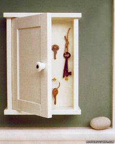 an open cabinet with keys in it on the wall